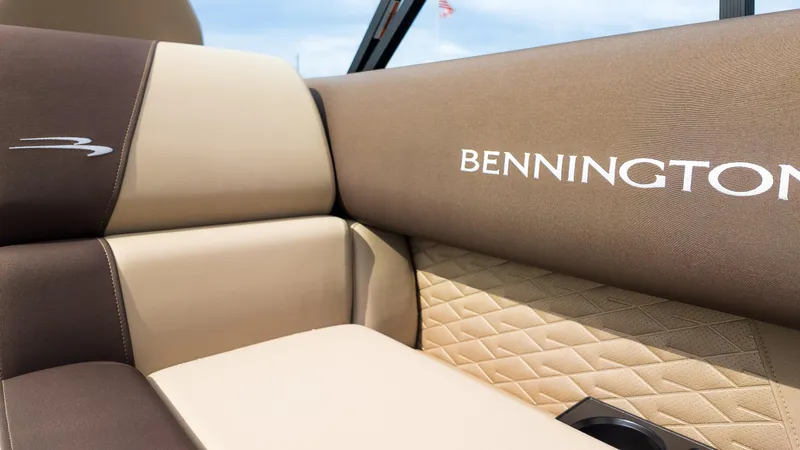 Slide: The Image of 2025 Bennington 22 SSR boat interior with beige and brown seating. - 15