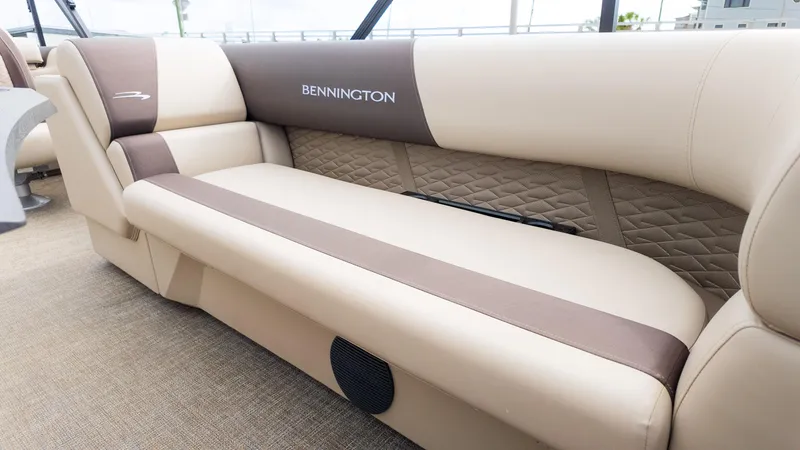 Slide: The Image of 2025 Bennington 22 SSR boat interior with beige and brown cushioned seating. - 18