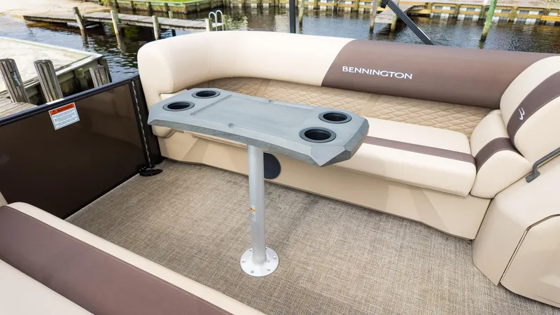 Slide: The Image of 2025 Bennington 22 SSR boat interior with cushioned seating and cupholder table. - 21