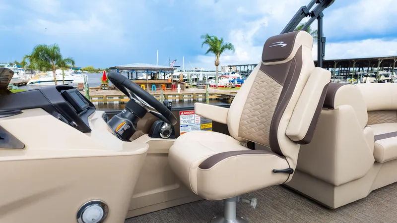 Slide: The Image of 2025 Bennington 22 SSR boat interior with luxurious captain's chair and steering console. - 23