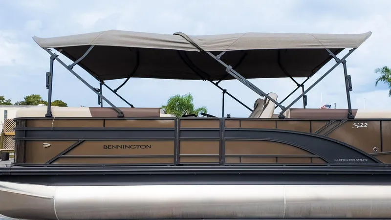 Slide: The Image of 2025 Bennington 22 SSR pontoon boat with canopy, side view. - 31