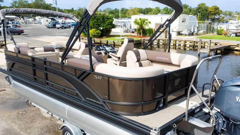 Slide: The Image of 2025 Bennington 22 SSR pontoon boat docked, featuring spacious seating and modern design. - 5