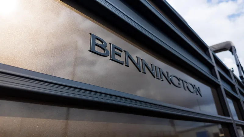 Slide: The Image of 2025 Bennington 22 SSR boat, close-up of logo on metallic surface. - 6