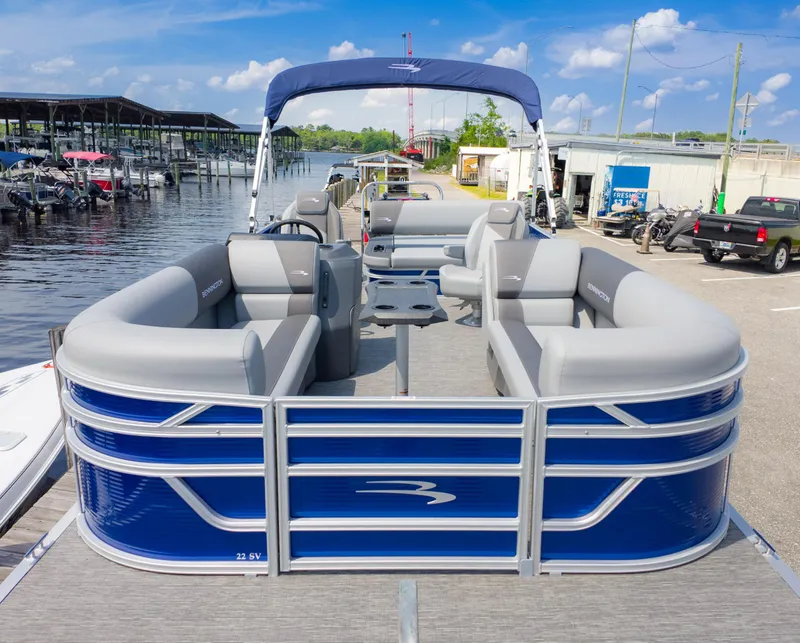 Slide: The Image of 2024 Bennington 22 SVSB pontoon boat docked, featuring spacious seating and sleek design. - 1