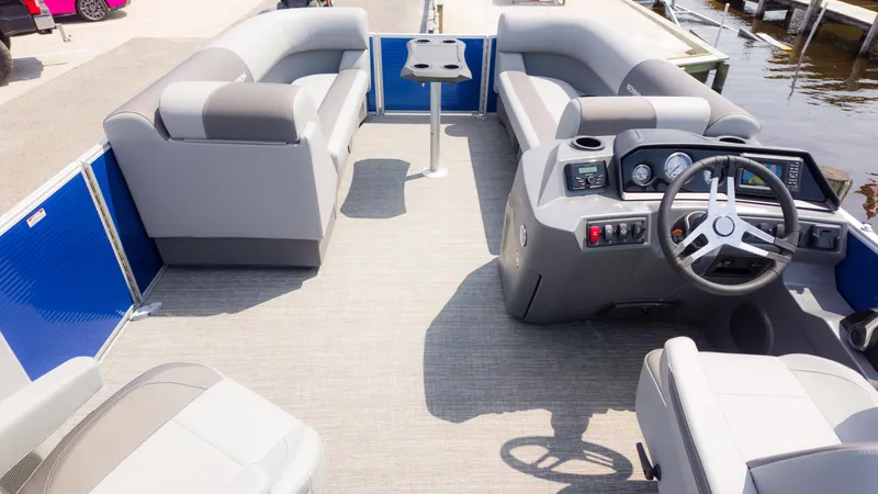 Slide: The Image of 2024 Bennington 22 SVSB pontoon boat interior with gray seating and modern dashboard. - 11