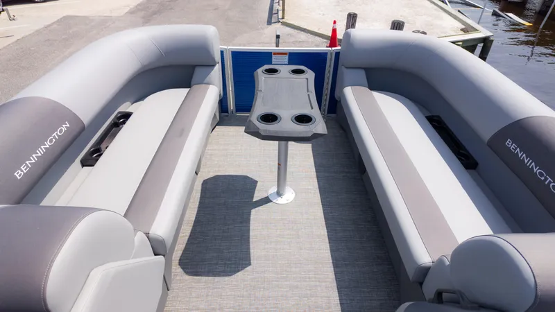 Slide: The Image of 2024 Bennington 22 SVSB pontoon boat interior with gray seating and central table. - 12