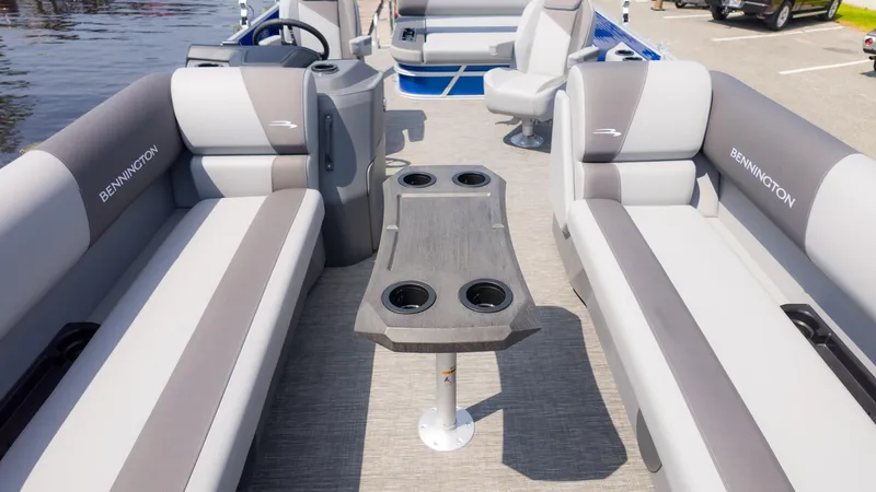 Slide: The Image of 2024 Bennington 22 SVSB pontoon boat interior with gray seating and central table. - 13