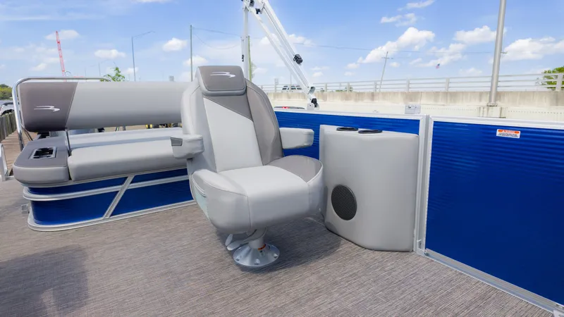 Slide: The Image of 2024 Bennington 22 SVSB pontoon boat interior with gray seating and blue accents. - 19