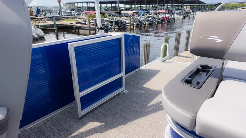 Slide: The Image of 2024 Bennington 22 SVSB pontoon boat interior with blue paneling and seating. - 21