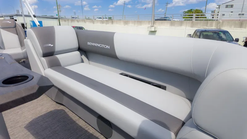 Slide: The Image of 2024 Bennington 22 SVSB boat interior with gray seating and cup holders. - 22
