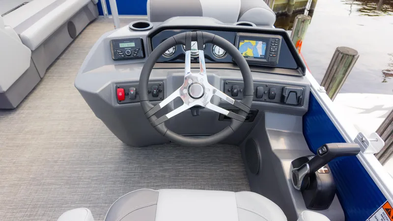 Slide: The Image of 2024 Bennington 22 SVSB boat dashboard with steering wheel and navigation system. - 28