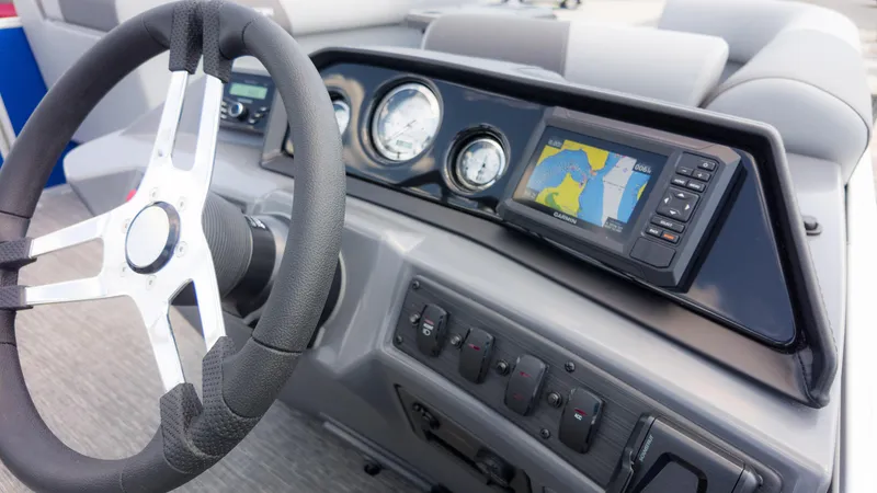 Slide: The Image of 2024 Bennington 22 SVSB dashboard with steering wheel and navigation system. - 30