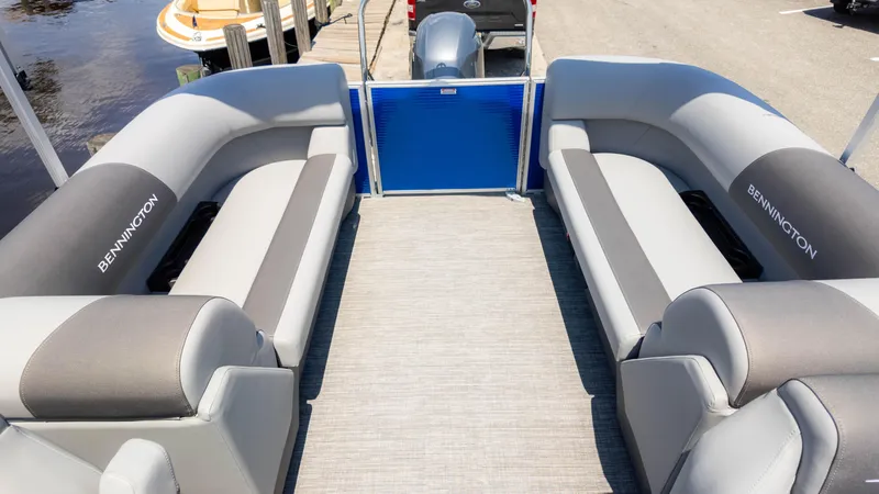Slide: The Image of 2024 Bennington 22 SVSR pontoon boat interior with gray seating and blue accents. - 10