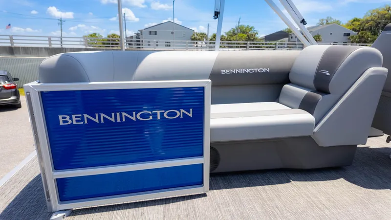 Slide: The Image of 2024 Bennington 22 SVSR pontoon boat with gray seating and blue paneling. - 14