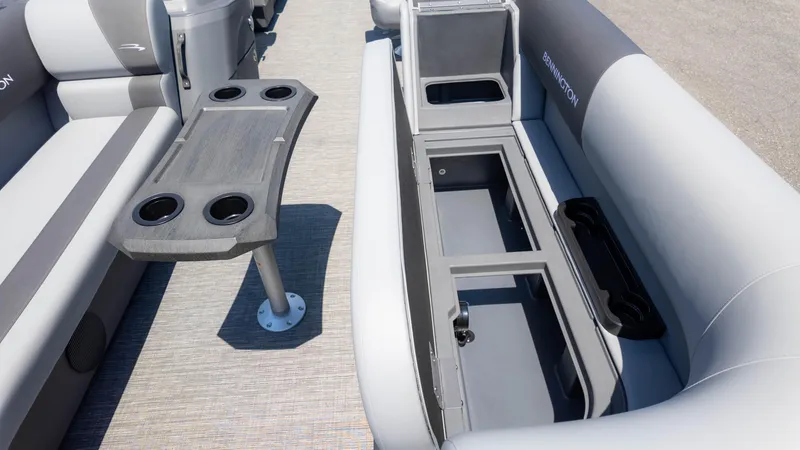 Slide: The Image of 2024 Bennington 22 SVSR boat interior with seating, storage compartments, and cup holders. - 19