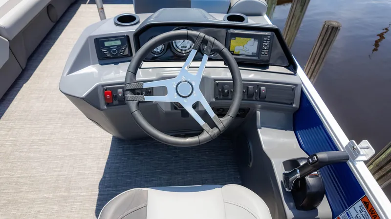Slide: The Image of 2024 Bennington 22 SVSR boat dashboard with steering wheel and navigation controls. - 23
