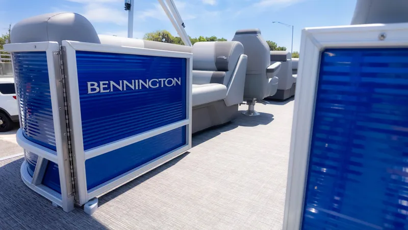 Slide: The Image of 2024 Bennington 22 SVSR pontoon boat interior with blue paneling and gray seating. - 4
