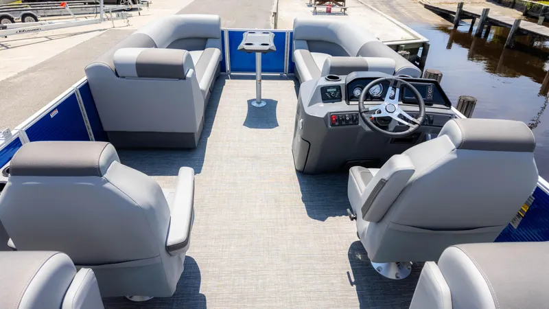Slide: The Image of 2024 Bennington 22 SVSR pontoon boat interior with gray seating and modern dashboard. - 6