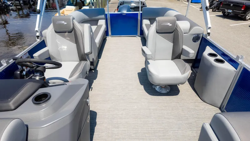 Slide: The Image of 2024 Bennington 22 SVSR pontoon boat interior with gray seating and steering console. - 9