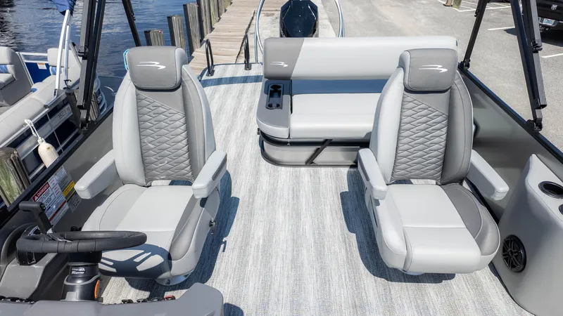 Slide: The Image of 2025 Bennington 23 SSB boat interior with gray seating and steering wheel. - 12