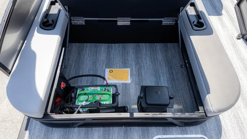 Slide: The Image of 2025 Bennington 23 SSB boat storage compartment with battery and seating. - 14