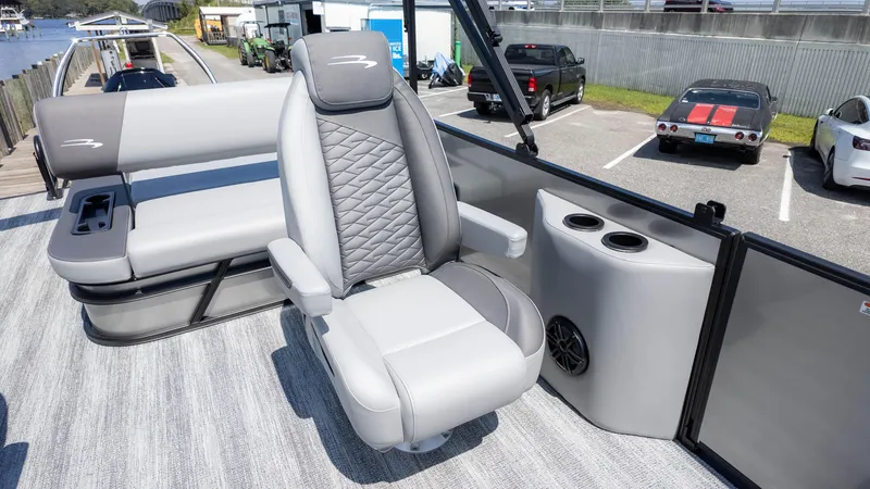 Slide: The Image of 2025 Bennington 23 SSB boat interior with plush seating and cup holders. - 16