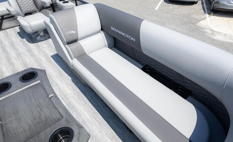 Slide: The Image of 2025 Bennington 23 SSB boat interior with gray seating and cup holders. - 18