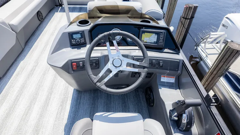 Slide: The Image of 2025 Bennington 23 SSB boat dashboard with steering wheel and navigation system. - 22