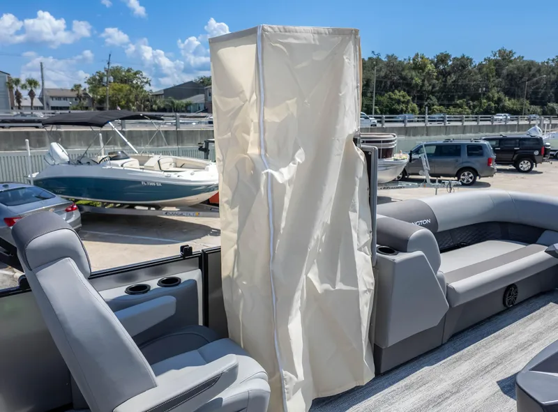 Slide: The Image of 2025 Bennington 23 SSB pontoon boat interior with seating and privacy curtain. - 26