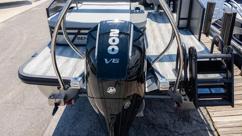 Slide: The Image of 2025 Bennington 23 SSB boat with Mercury 200 V6 engine, docked on a sunny day. - 6