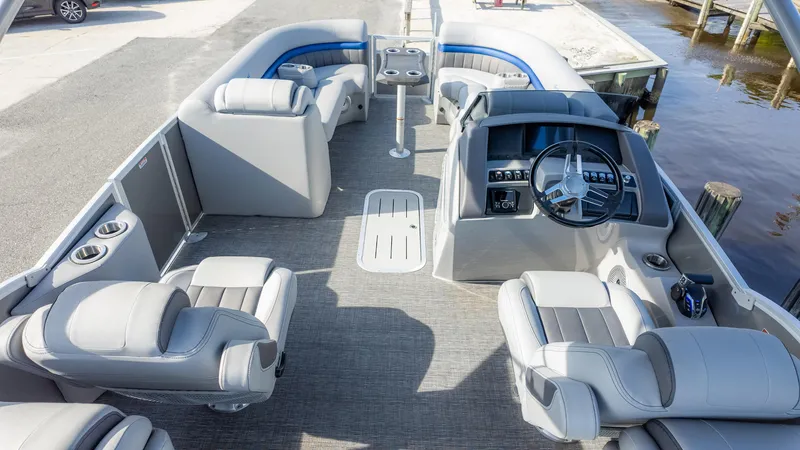 Slide: The Image of 2024 Bennington 24 LXSFBA pontoon boat interior with luxurious seating and modern helm. - 10