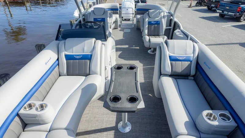 Slide: The Image of 2024 Bennington 24 LXSFBA pontoon boat interior with luxurious seating and cup holders. - 12