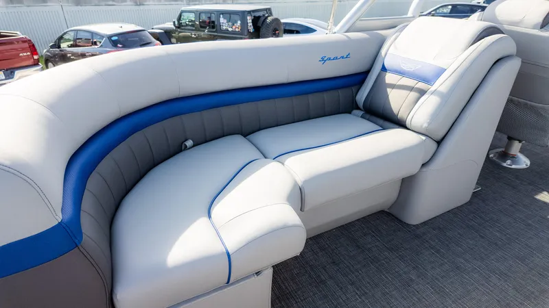 Slide: The Image of 2024 Bennington 24 LXSFBA boat interior with luxurious gray and blue seating. - 16