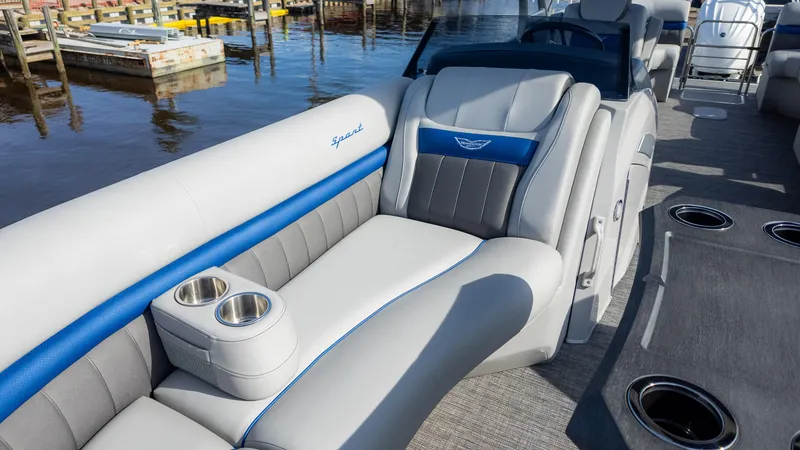 Slide: The Image of 2024 Bennington 24 LXSFBA pontoon boat interior with plush seating and cup holders. - 24