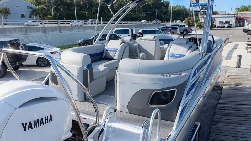 Slide: The Image of 2024 Bennington 24 LXSFBA pontoon boat with Yamaha engine, docked in a marina. - 5