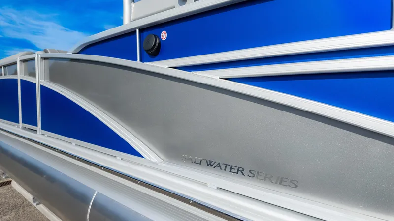 Slide: The Image of 2024 Bennington 24 LXSFBA Saltwater Series pontoon boat with blue and silver design. - 8