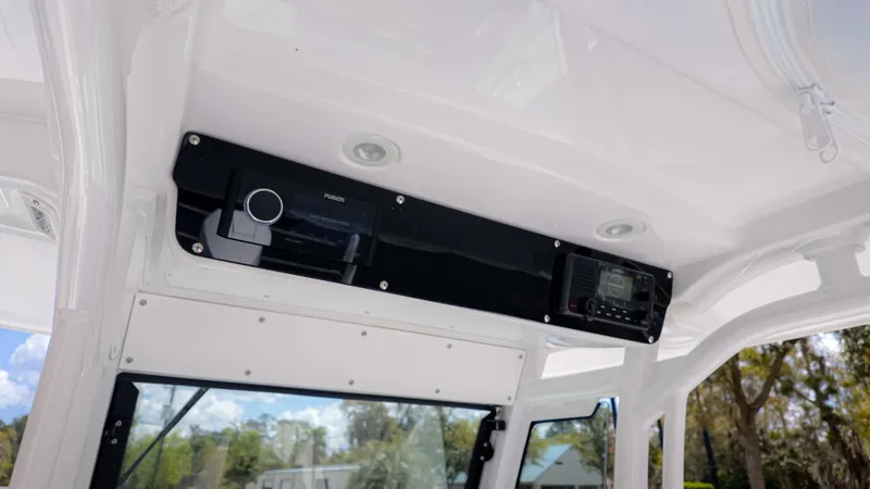 Slide: The Image of 2025 Everglades 253CC boat interior with modern audio system and sleek design. - 15