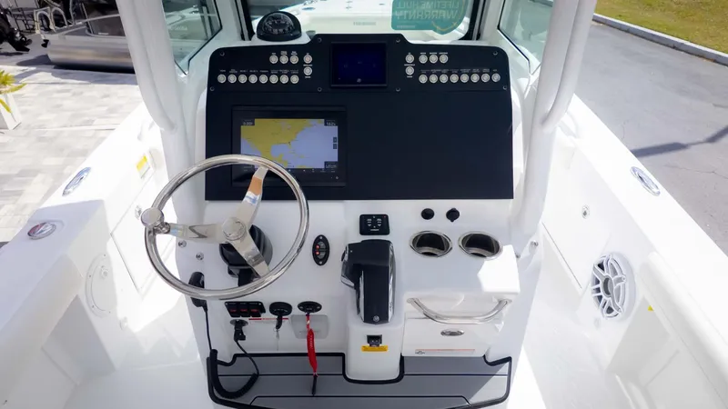 Slide: The Image of 2025 Everglades 253CC boat dashboard with steering wheel and navigation system. - 16