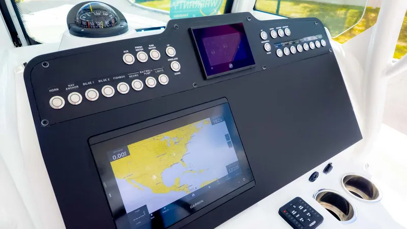 Slide: The Image of Control panel of 2025 Everglades 253CC boat with navigation and control systems. - 17