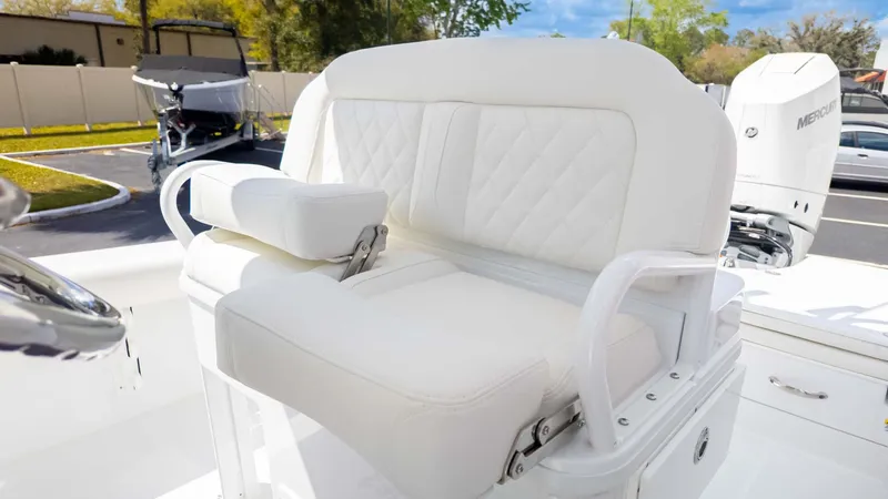 Slide: The Image of 2025 Everglades 253CC boat with white cushioned seating and Mercury engine. - 18