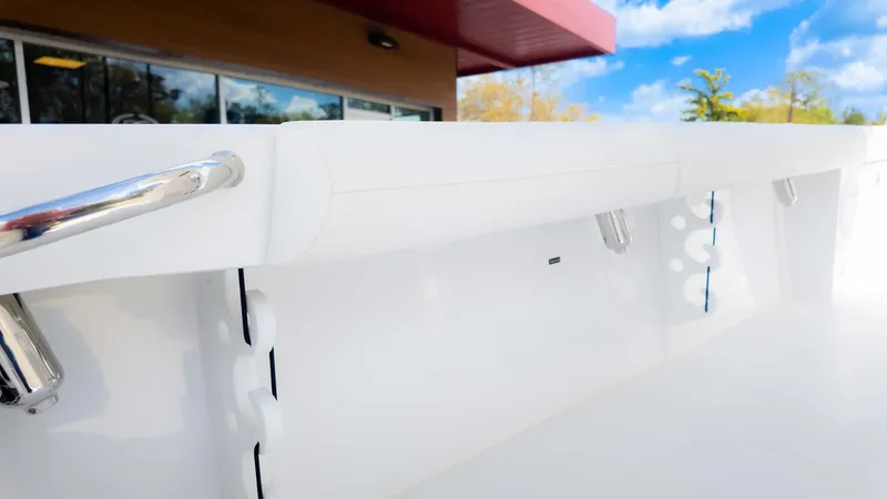 Slide: The Image of 2025 Everglades 253CC boat interior with sleek white design and stainless steel accents. - 20