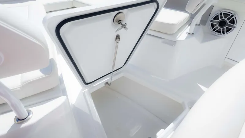 Slide: The Image of 2025 Everglades 253CC boat storage compartment with open hatch and seating area. - 22
