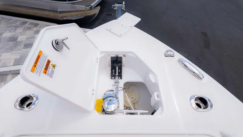Slide: The Image of Open anchor compartment on 2025 Everglades 253CC boat, showcasing storage and hardware. - 23