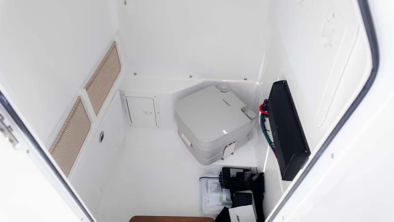 Slide: The Image of Interior of 2025 Everglades 253CC boat, featuring storage and equipment compartments. - 24