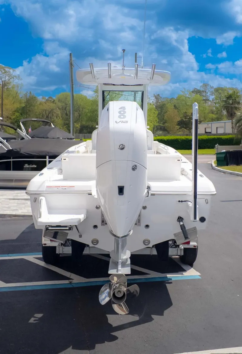 Slide: The Image of 2025 Everglades 253CC boat with powerful outboard motor, parked under a clear blue sky. - 5