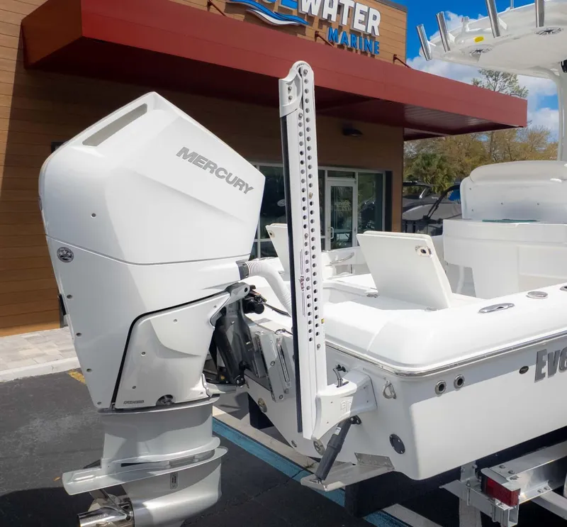 Slide: The Image of 2025 Everglades 253CC boat with Mercury outboard motor at dealership. - 6