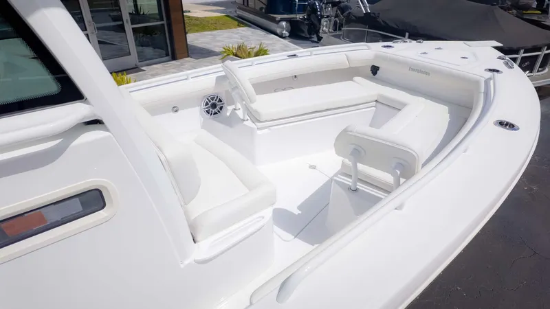 Slide: The Image of 2025 Everglades 253CC boat interior with white seating and modern design. - 9