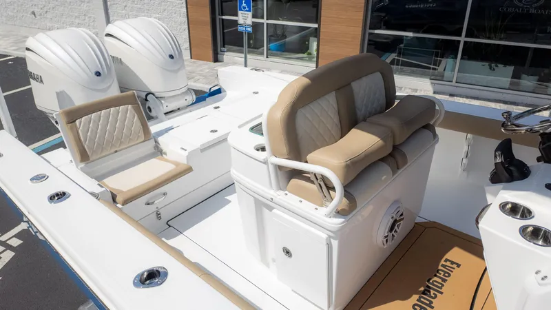 Slide: The Image of 2025 Everglades 273CC boat interior with dual Yamaha engines and cushioned seating. - 10
