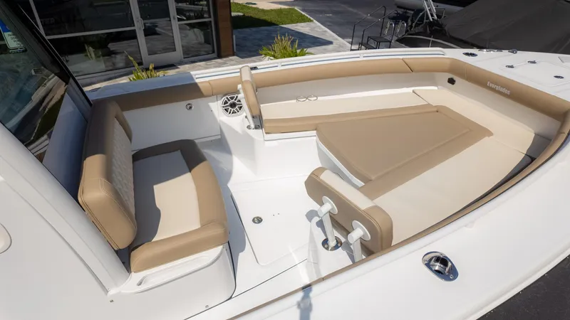 Slide: The Image of 2025 Everglades 273CC boat interior with beige seating and modern design. - 11