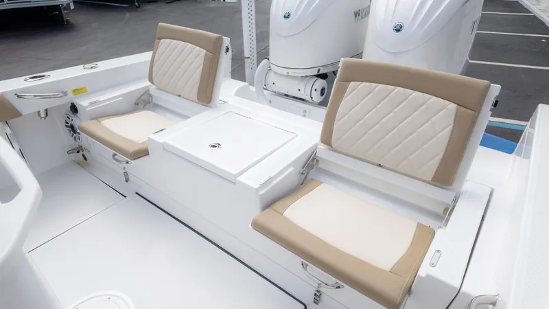 Slide: The Image of 2025 Everglades 273CC boat seating area with beige and white cushioned seats. - 14